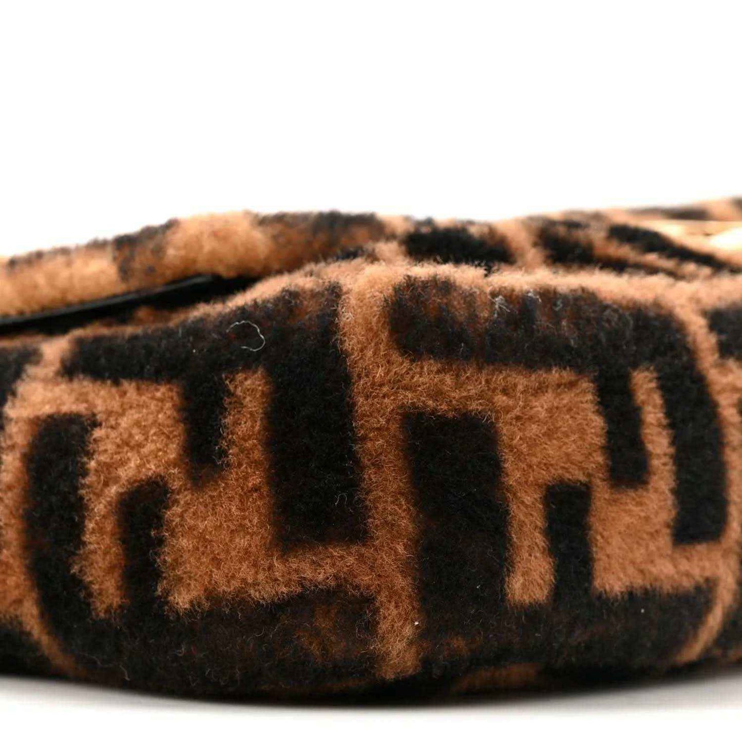 Tobacco-brown and black FF shearling panel on a Baguette bag, side view.