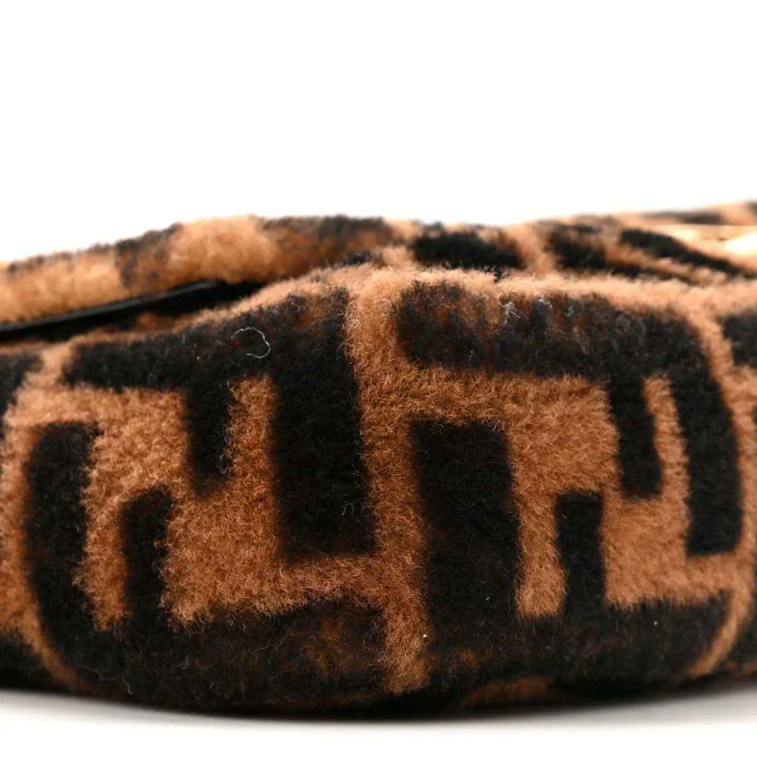 Tobacco-brown and black FF shearling panel on a Baguette bag, side view.