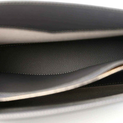 Black interior lining with stitched seam and braided trim along the edge