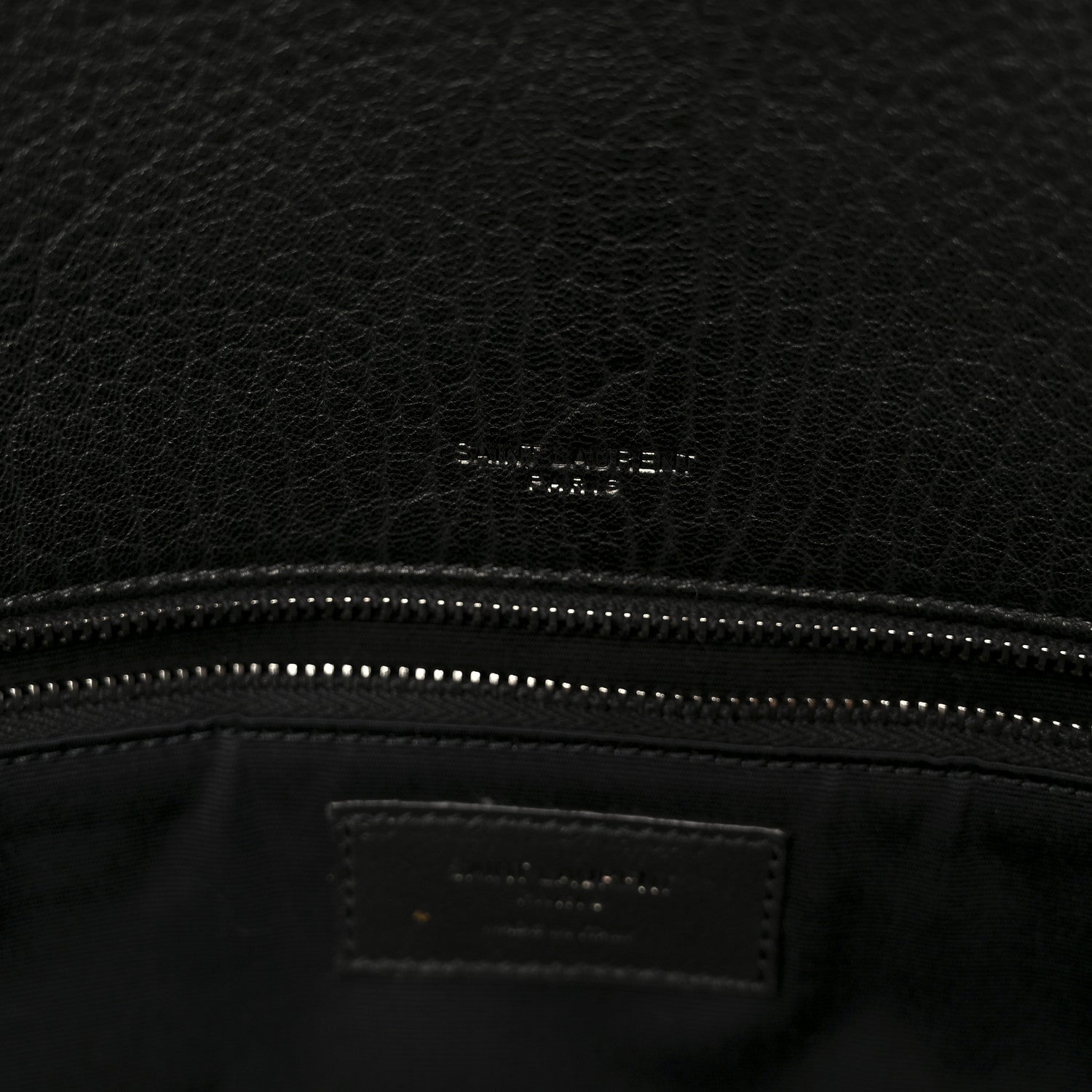 Black leather satchel interior logo patch and stitched zipper top