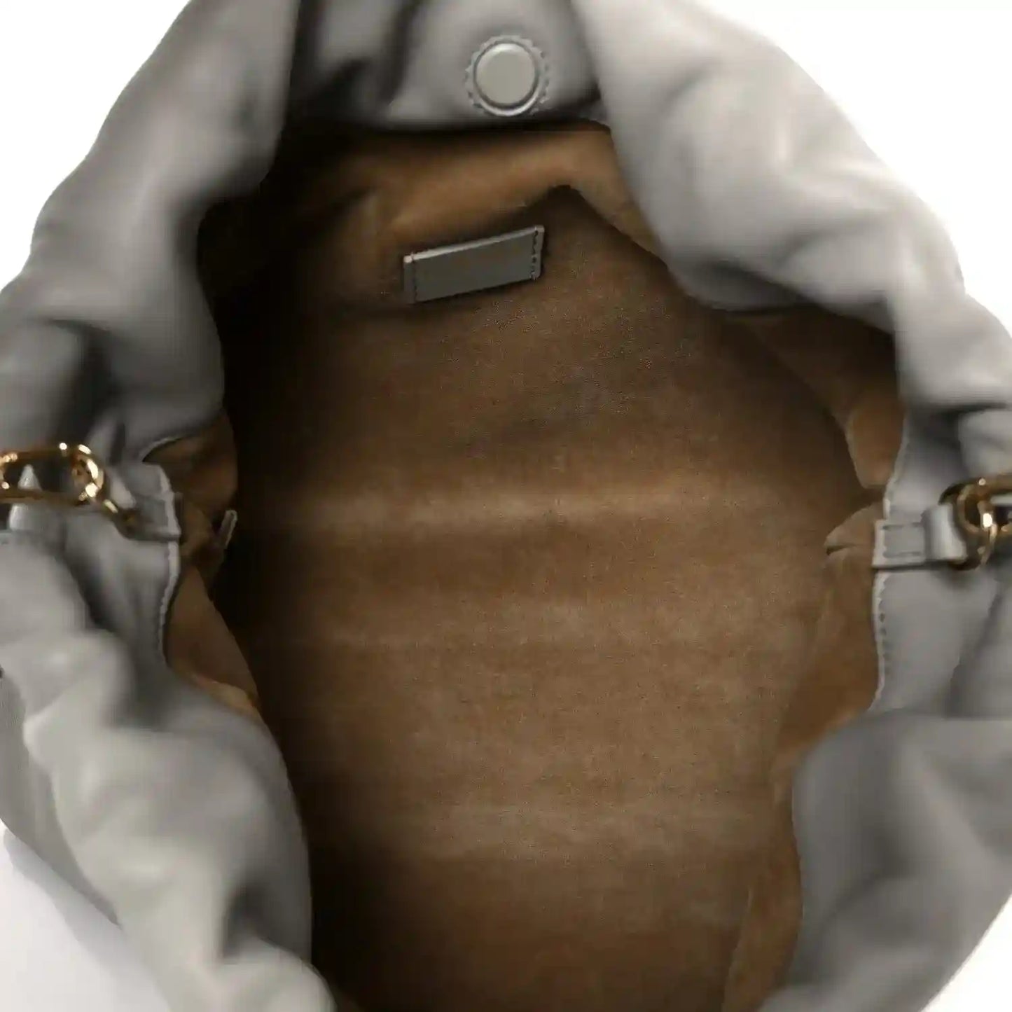 Loewe clutch interior with tan lining and metal clasp at the top