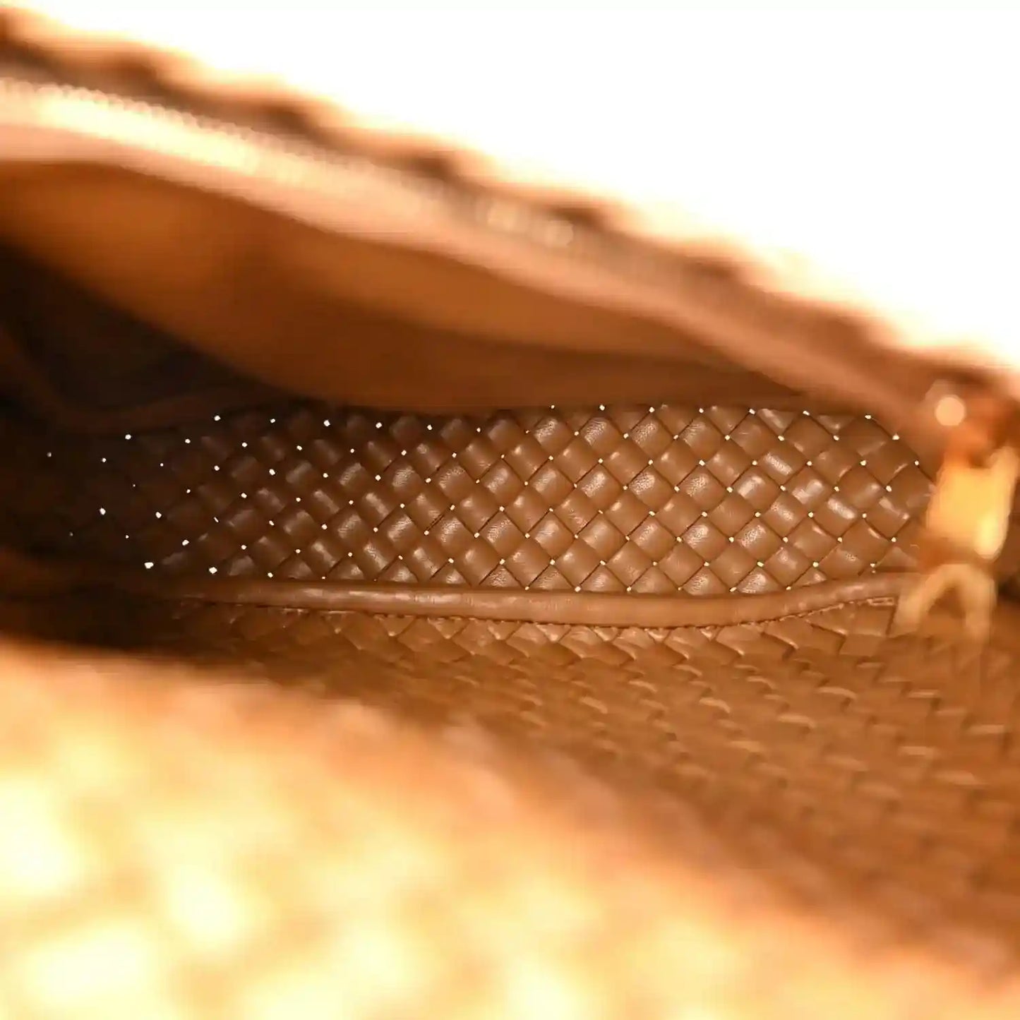 Caramel woven leather bag interior lining with cobble intreccio trim and stitched edge