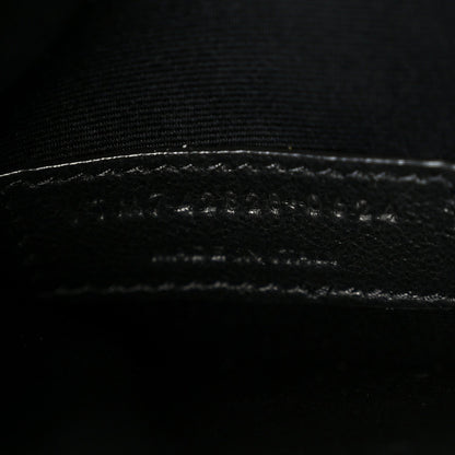 Saint Laurent shiny calfskin bucket bag, close-up of stitched leather trim