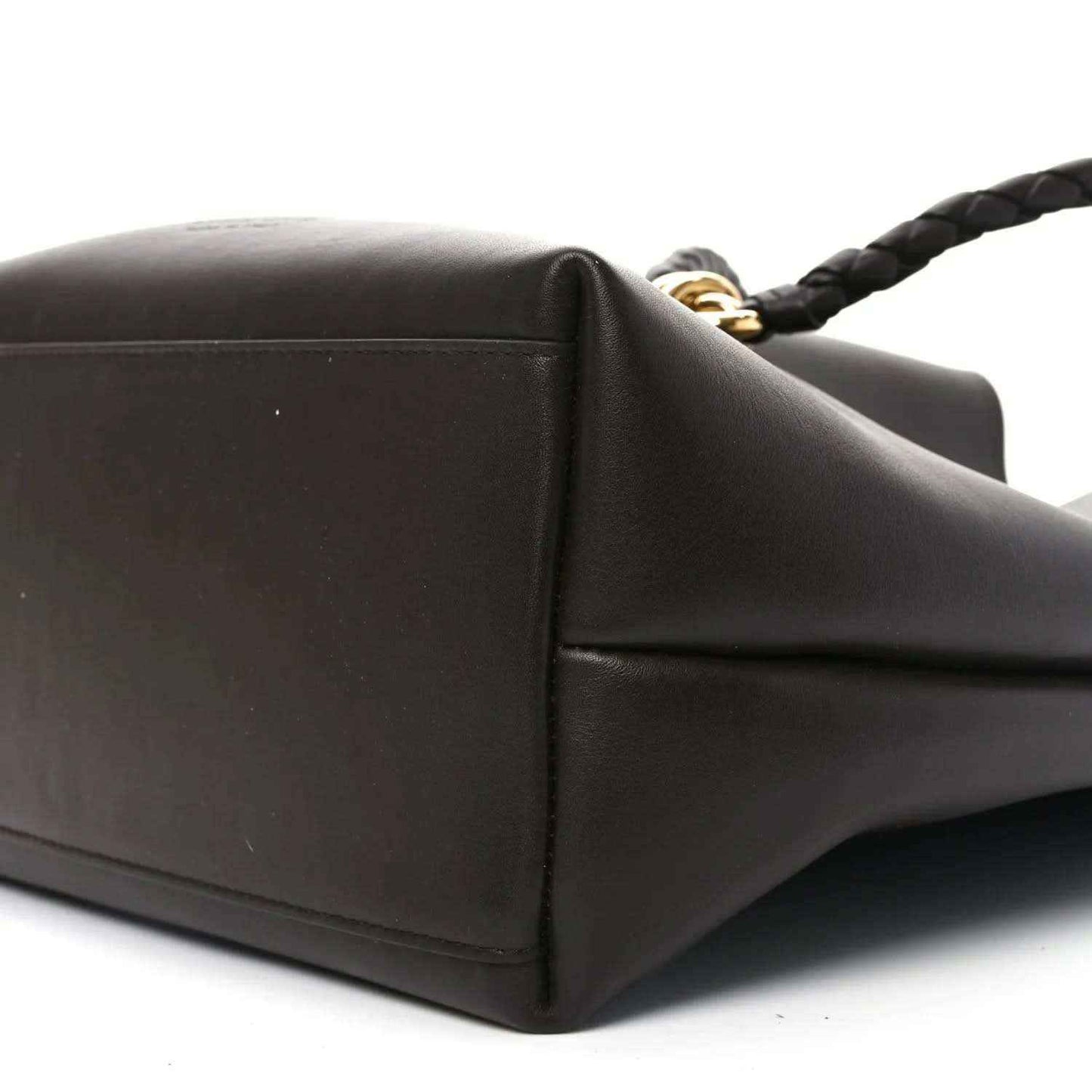 Small bucket bag side corner in dark leather with gold-tone strap hardware