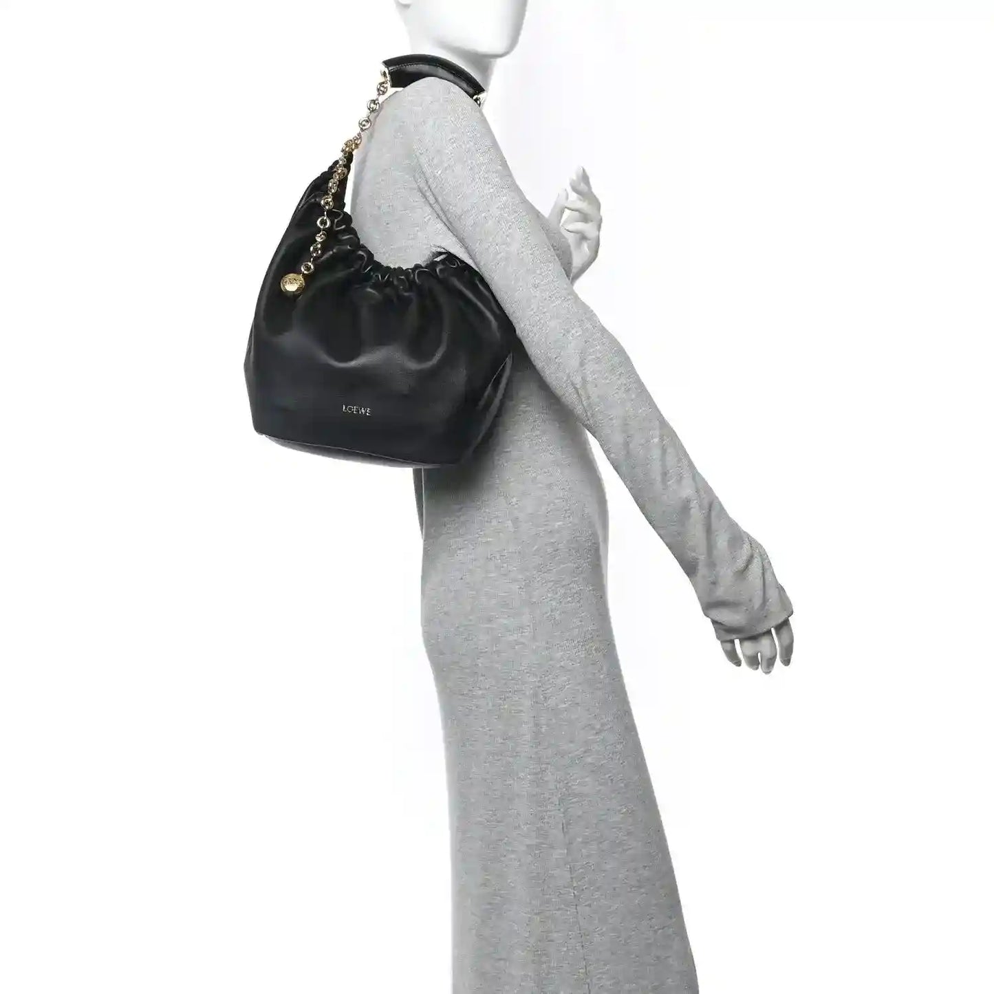 Loewe small squeeze bag in dark nappa leather with gold chain strap, held on wrist