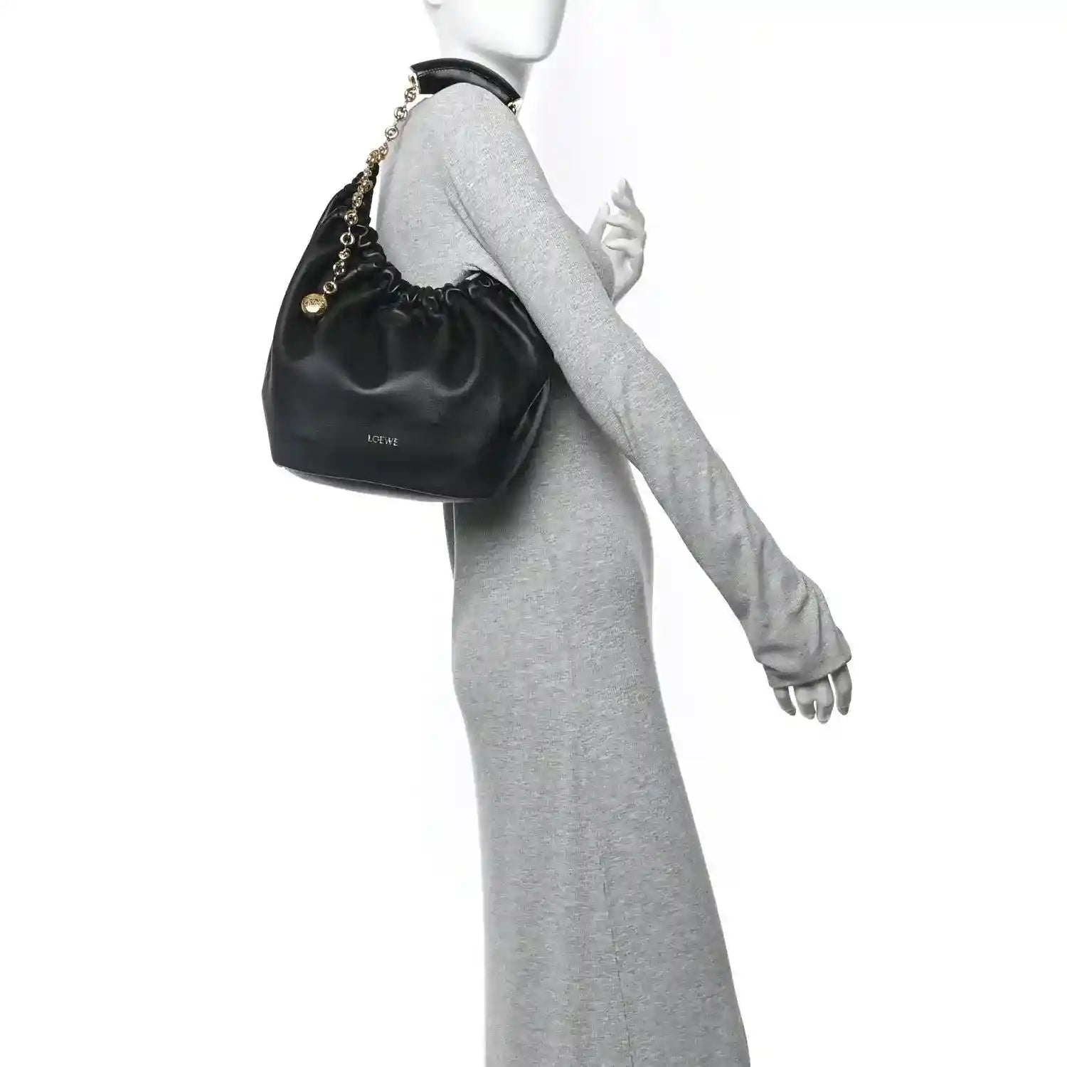 Loewe small squeeze bag in dark nappa leather with gold chain strap, held on wrist
