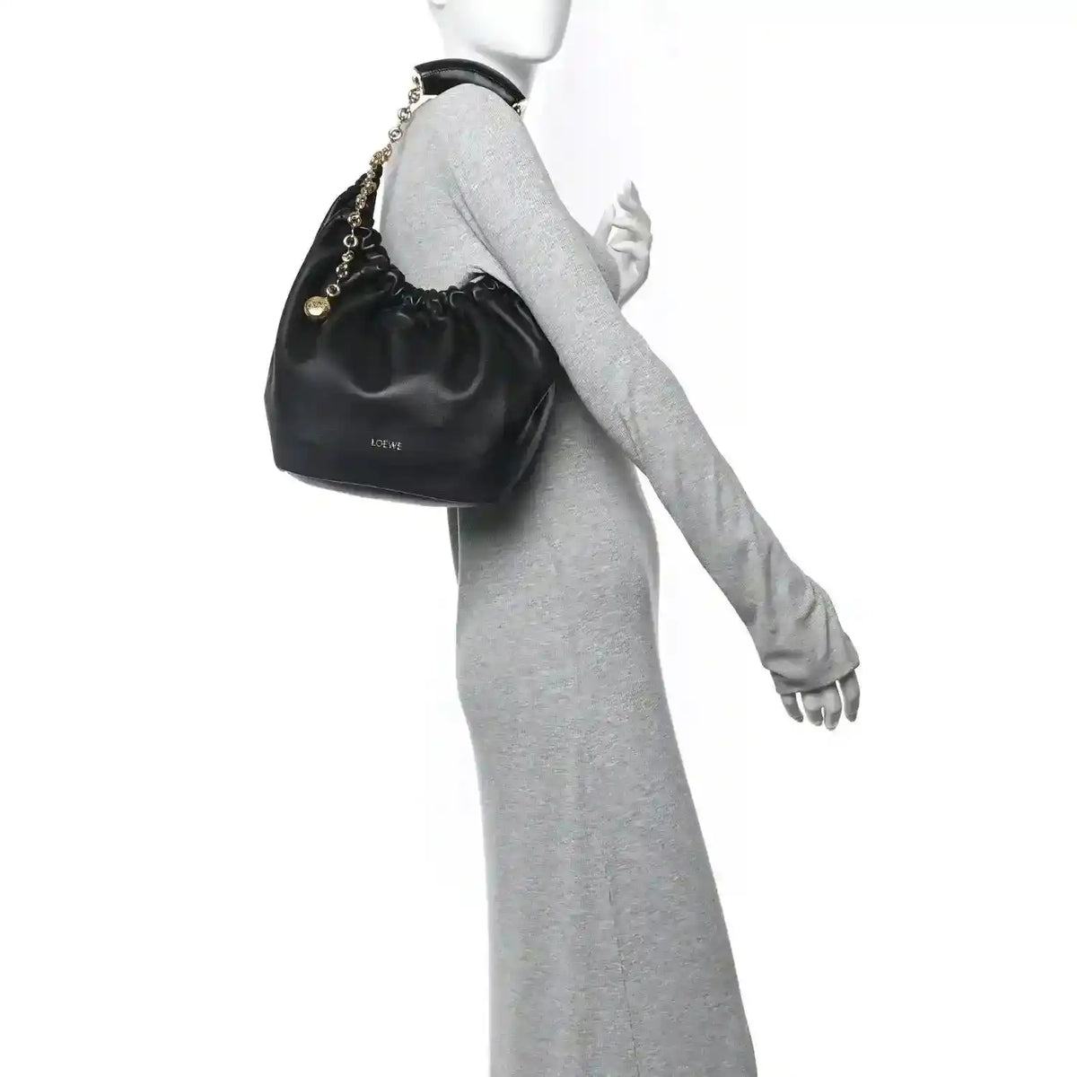 Loewe small squeeze bag in dark nappa leather with gold chain strap, held on wrist