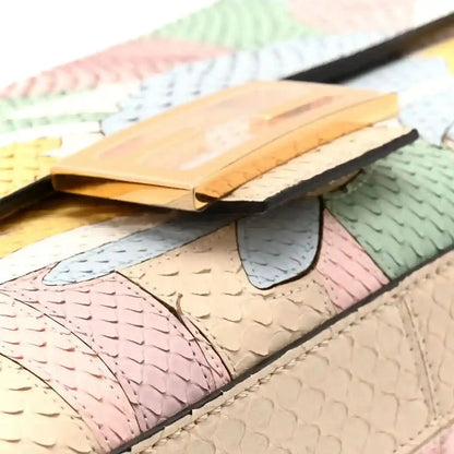 Snakeskin baguette handbag with multicolor panels, pink and green, black trim, top close-up