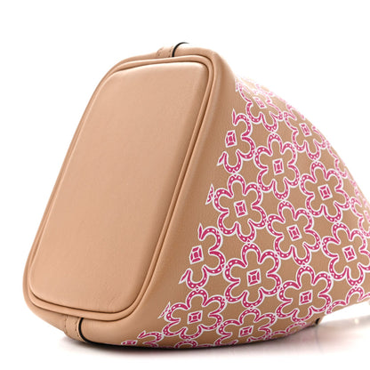 Micro tote bag side view with magenta floral panel and tan leather back