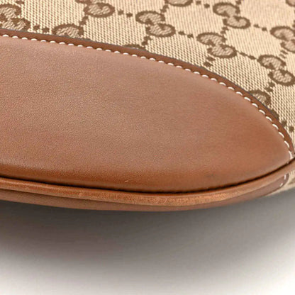 Large shoulder bag curved leather trim with visible stitching over monogram canvas