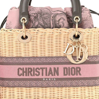 Wicker Lady Dior bag front with pink/gray stripe, gold Dior hardware and handles