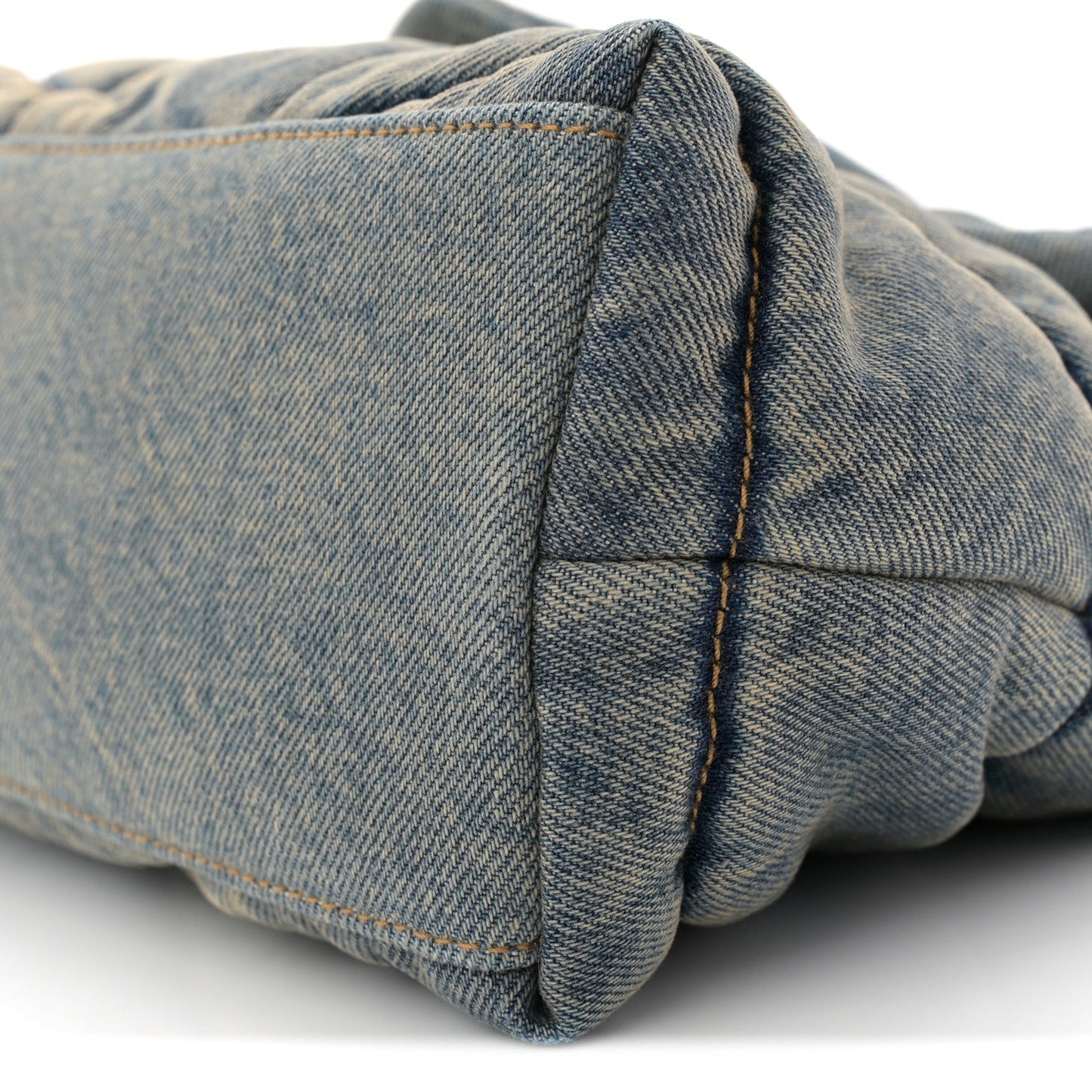 Denim quilted puffer satchel back corner with fold and seam detail