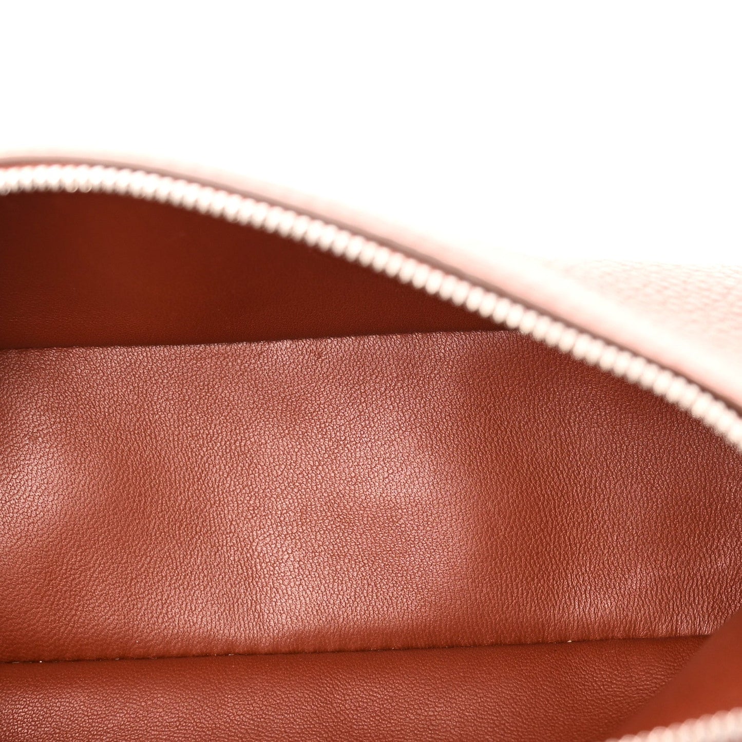 Close-up of grained calfskin pouch lining with white zipper trim