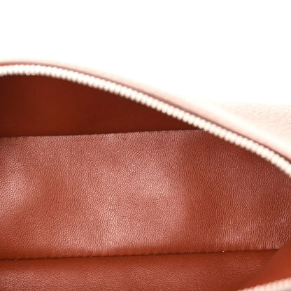 Close-up of grained calfskin pouch lining with white zipper trim