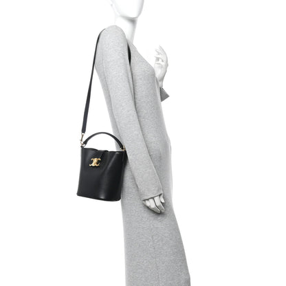 Small black Celine bag on shoulder strap, gold logo detail, smooth leather finish