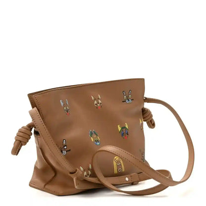 Tan smooth mini clutch with colorful animal prints and braided knotted side handles.