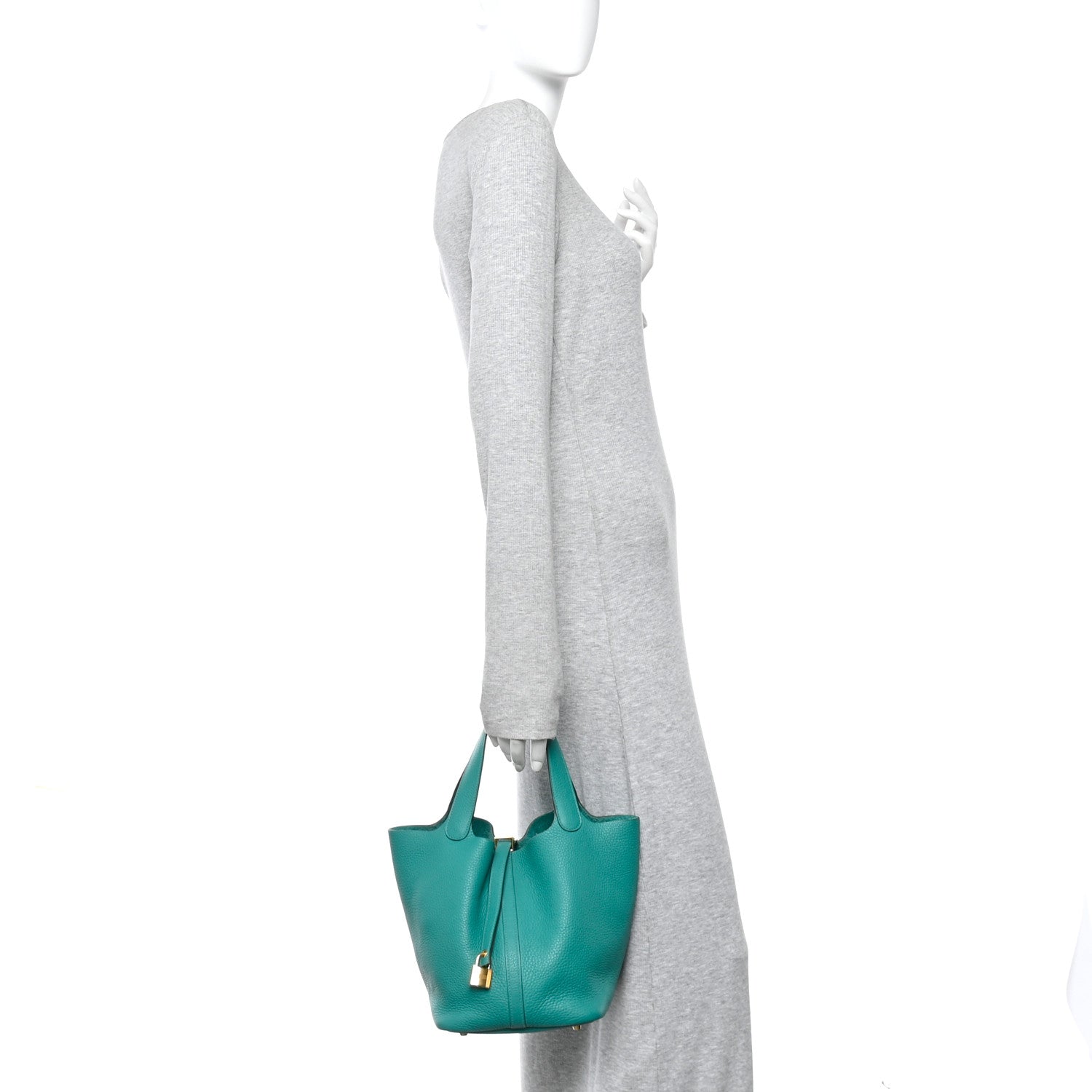 Green leather tote worn at side with top handles and gold-tone lock hardware