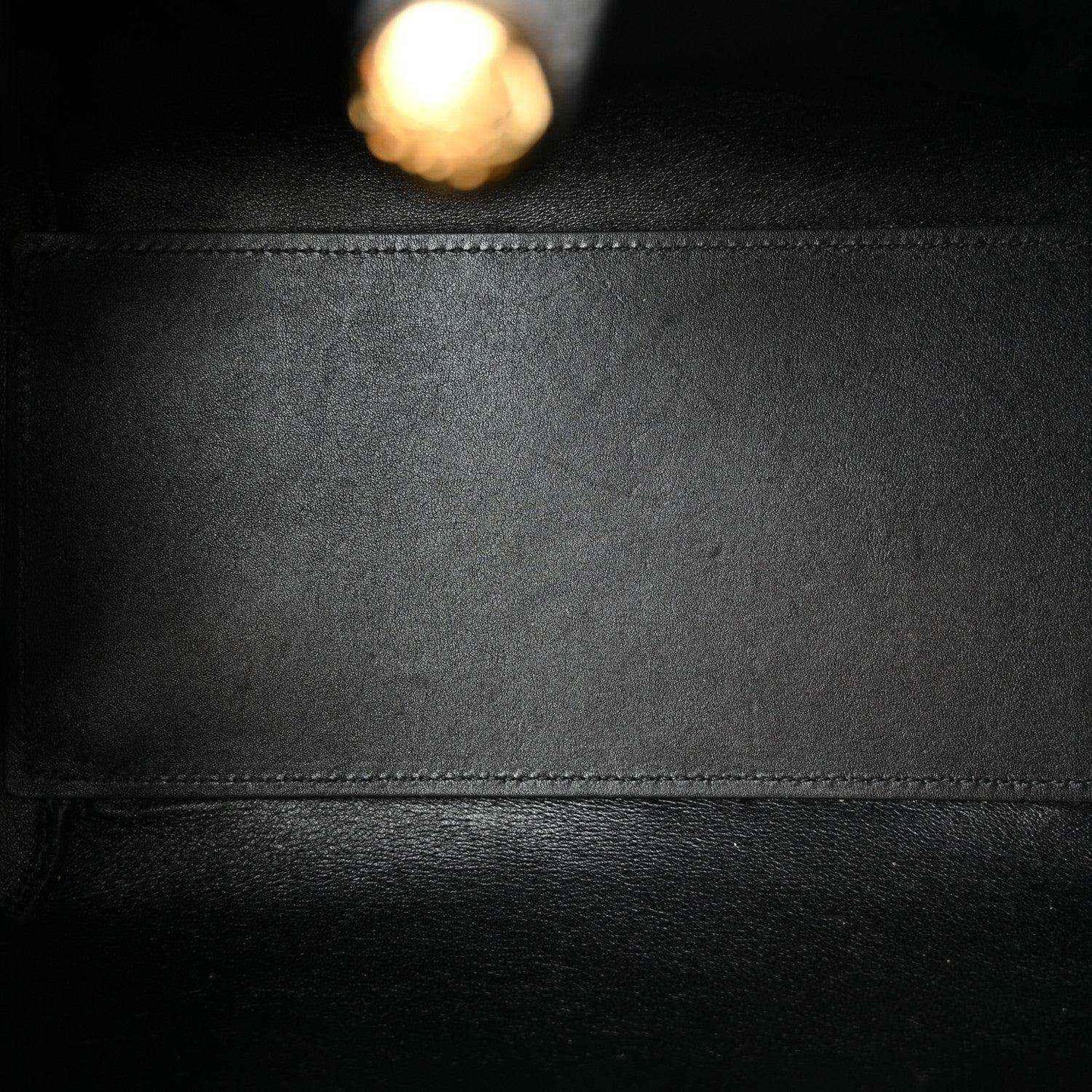 Calfskin leather panel in black with stitched seam and smooth grain texture.