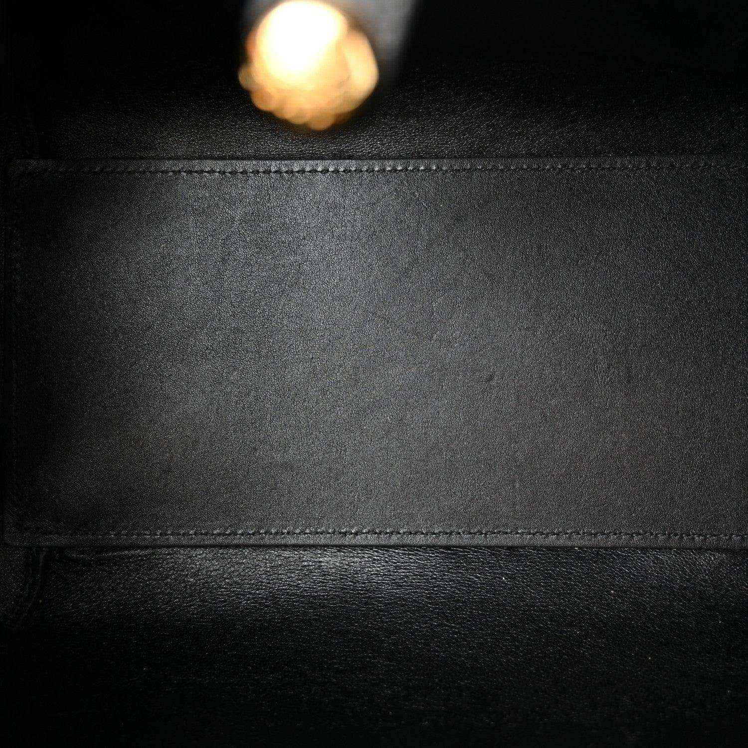 Calfskin leather panel in black with stitched seam and smooth grain texture.