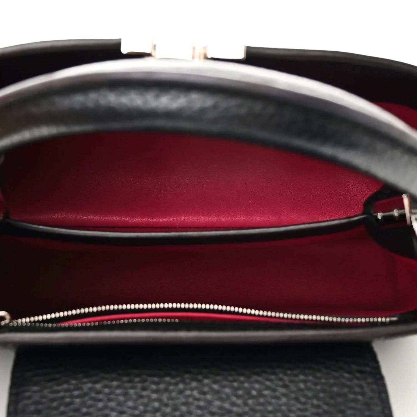 Black leather handbag interior with fuchsia lining and zip closure