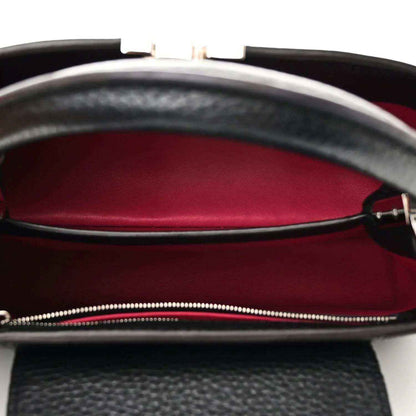 Black leather handbag interior with fuchsia lining and zip closure