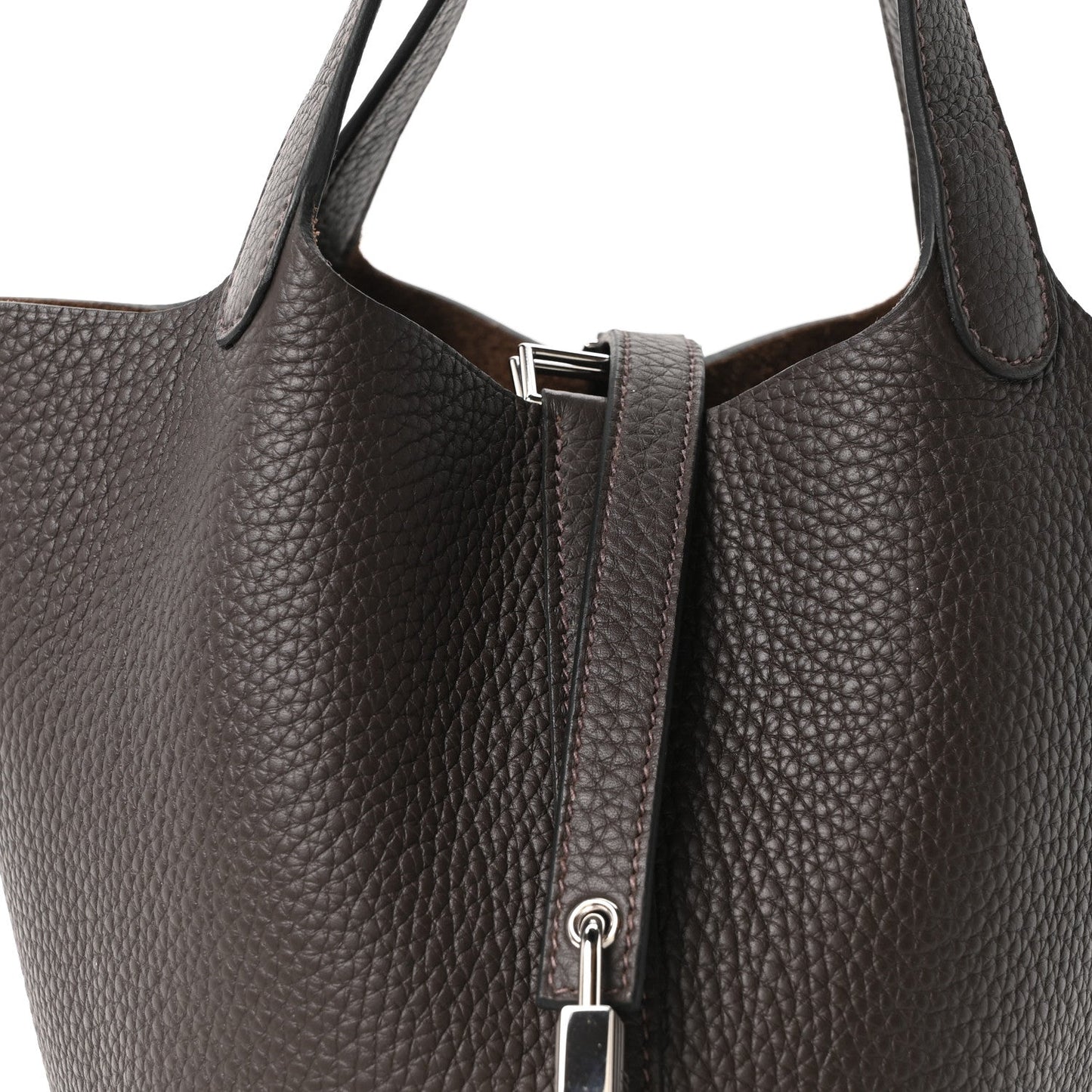 Dark brown leather tote bag top view with metal lock and strap hardware