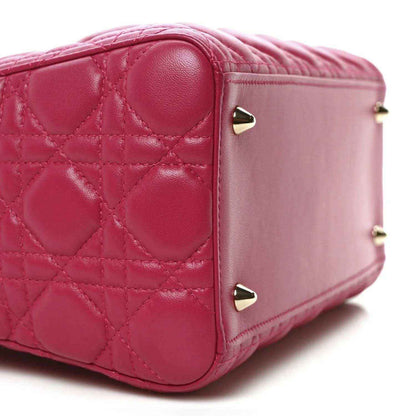 Fuchsia quilted leather handbag with rounded side panel and gold-tone hardware