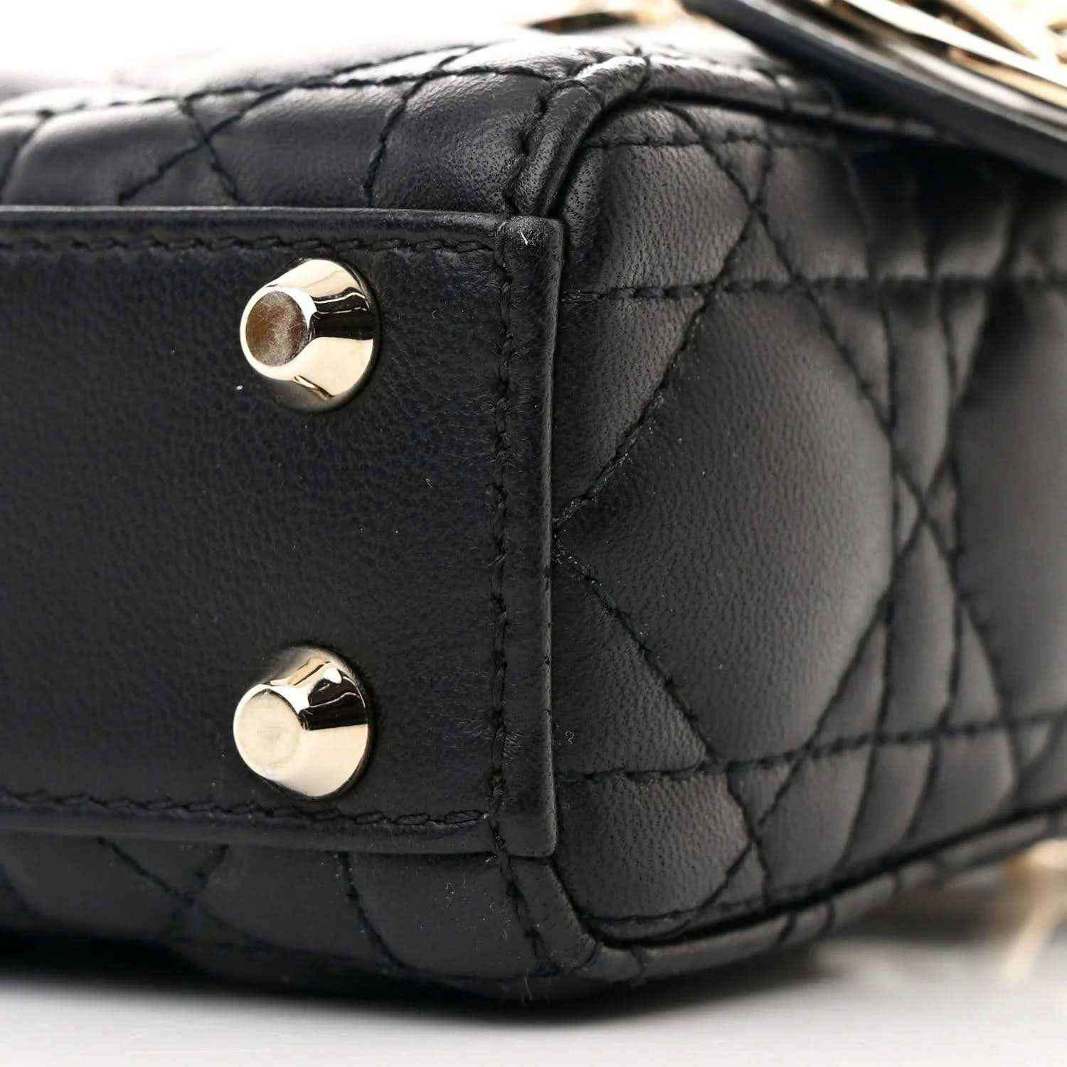 Black quilted micro handbag corner with gold-tone studs and leather trim