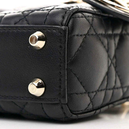 Black quilted micro handbag corner with gold-tone studs and leather trim