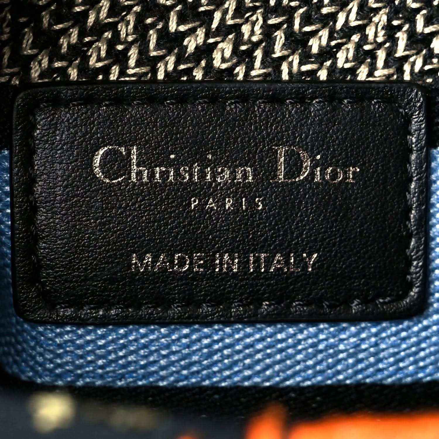 Black leather brand patch reading 'Christian Dior Paris' and 'Made in Italy'