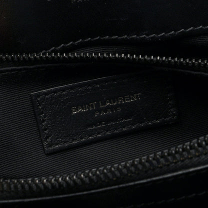Black fabric interior tag with “SAINT LAURENT” logo inside satchel