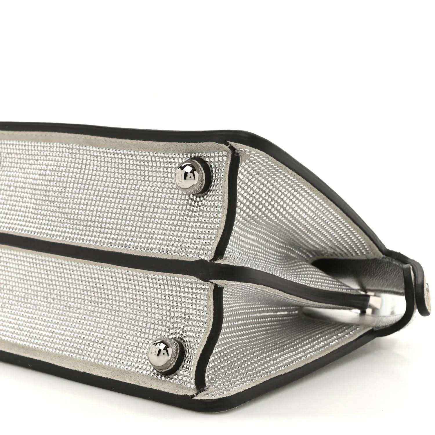 Silver crystal satchel strap attachments with metal buckles and leather trim