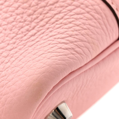 Pink leather handbag corner texture with metal lock detail