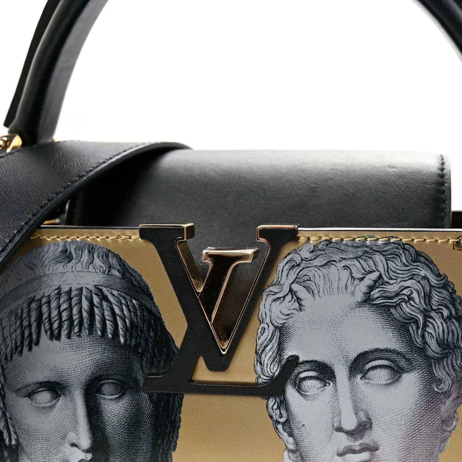 Handbag front close-up with gold LV-style logo, black flap trim, and face-print detail