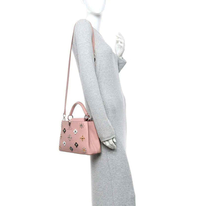 Pink mini handbag on shoulder strap with top handle and jeweled flower appliqués
