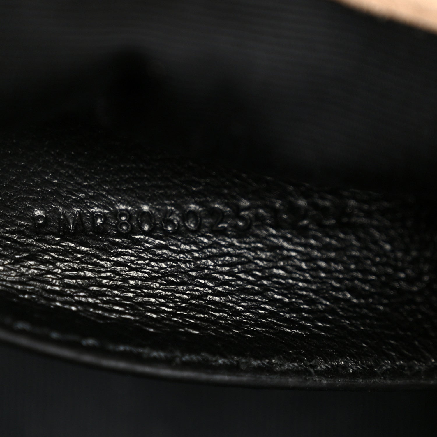 Black leather interior stamp with embossed serial-style numbers