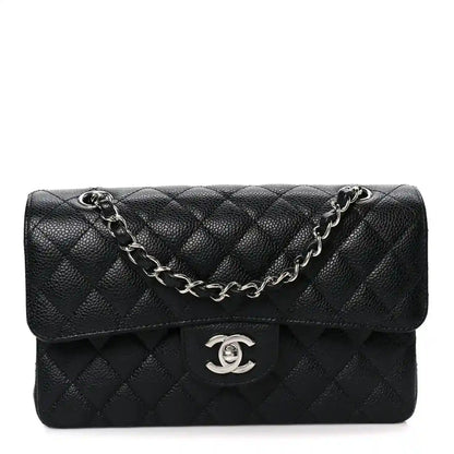 Black quilted leather double flap bag with chain strap and Chanel logo clasp
