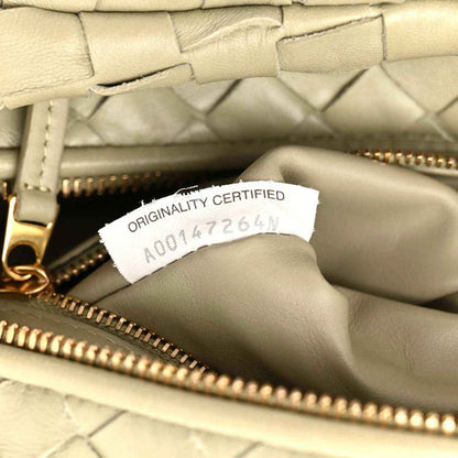 Leather bag interior with gold zipper and “ORIGINITY CERTIFIED” label