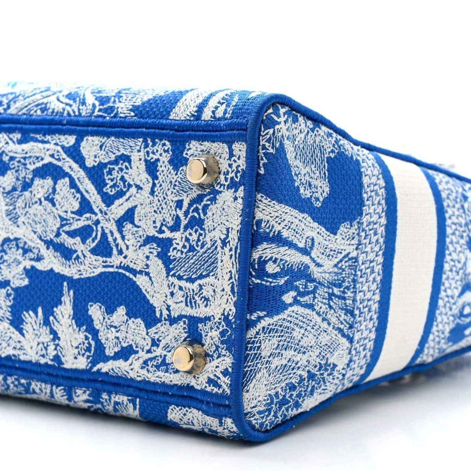 Dior tote bag bottom corner in blue Toile de Jouy print with gold snap and trim