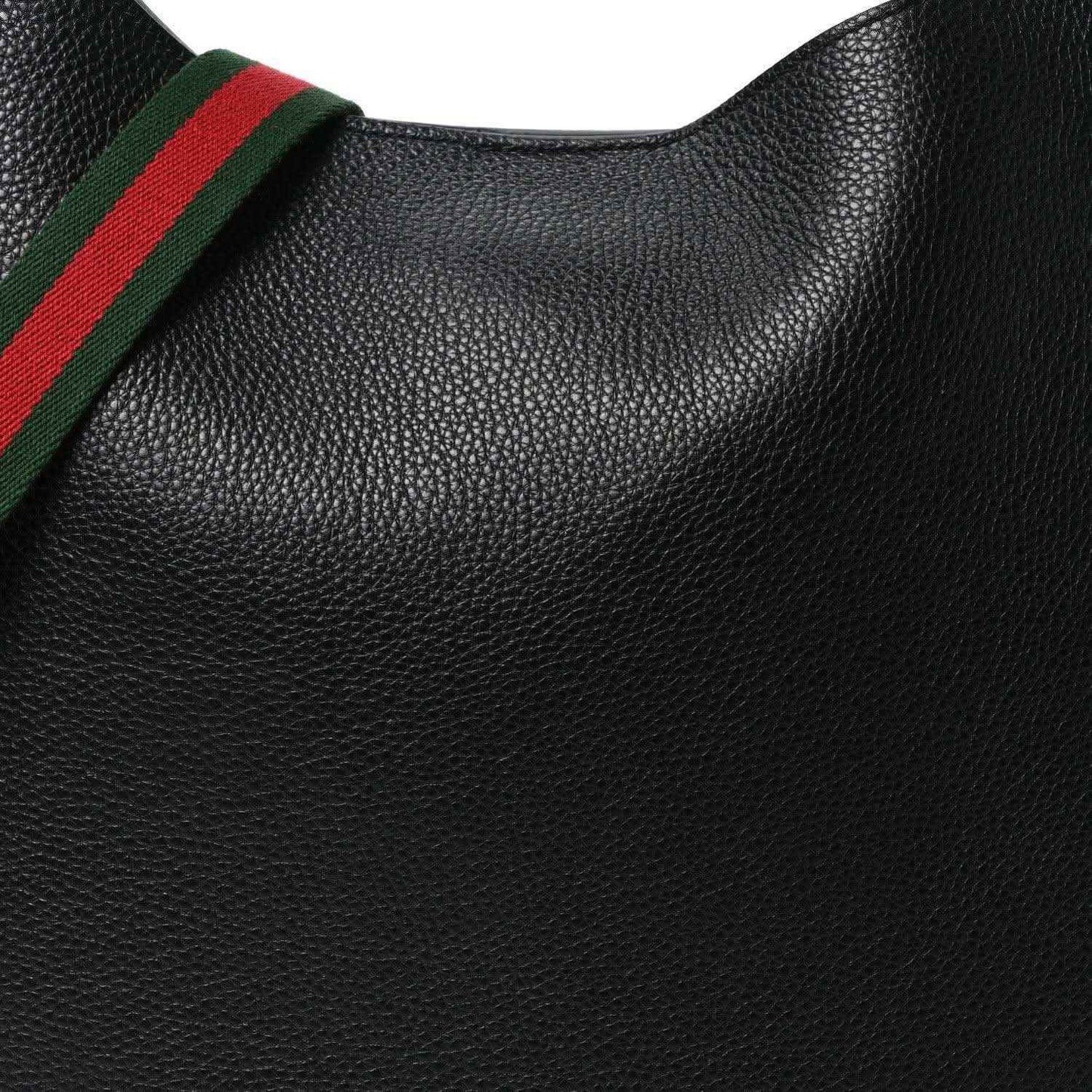 Black grained calfskin surface with green and red web strap edge