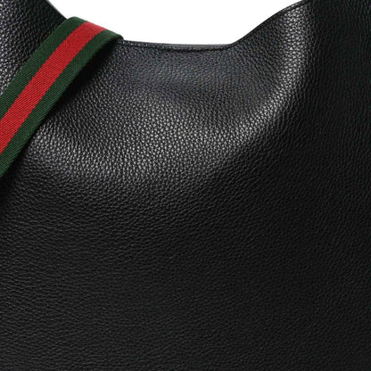 Black grained calfskin surface with green and red web strap edge