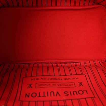 Red fabric interior lining with Louis Vuitton Paris label in tote bag