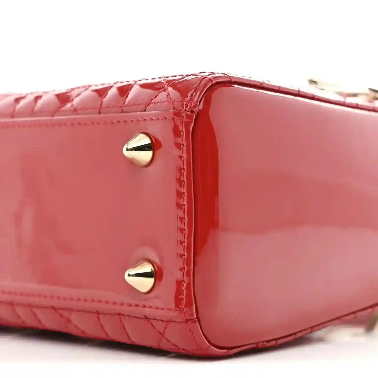 Christian Dior small red patent quilted handbag, close-up side panel with gold stud and trim