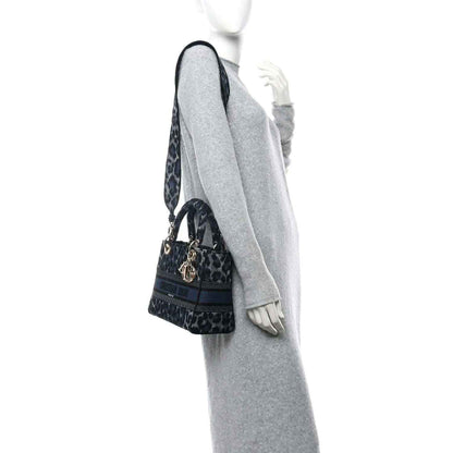 Christian Dior canvas handbag with leopard pattern and wide strap, side view