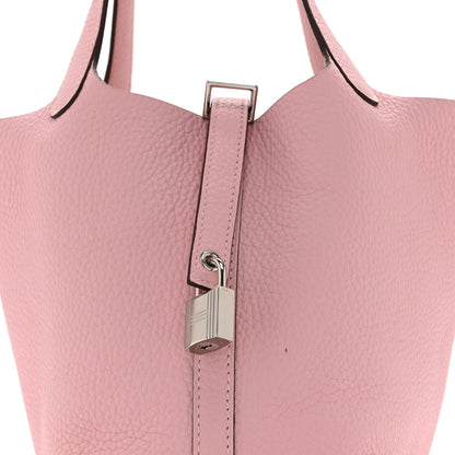 Mauve leather handbag top handle with central padlock closure and metal ring