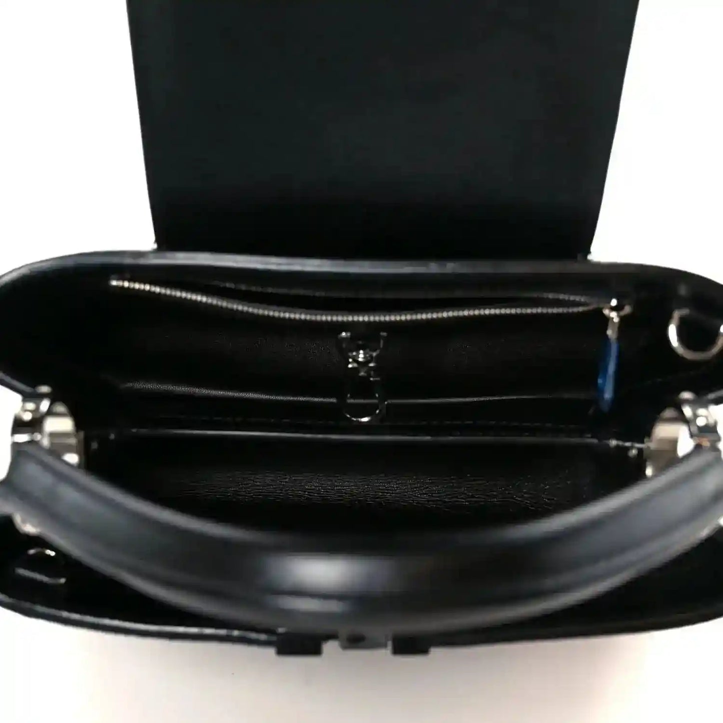 Capucines BB black bag open top showing inner compartment and zipper pull