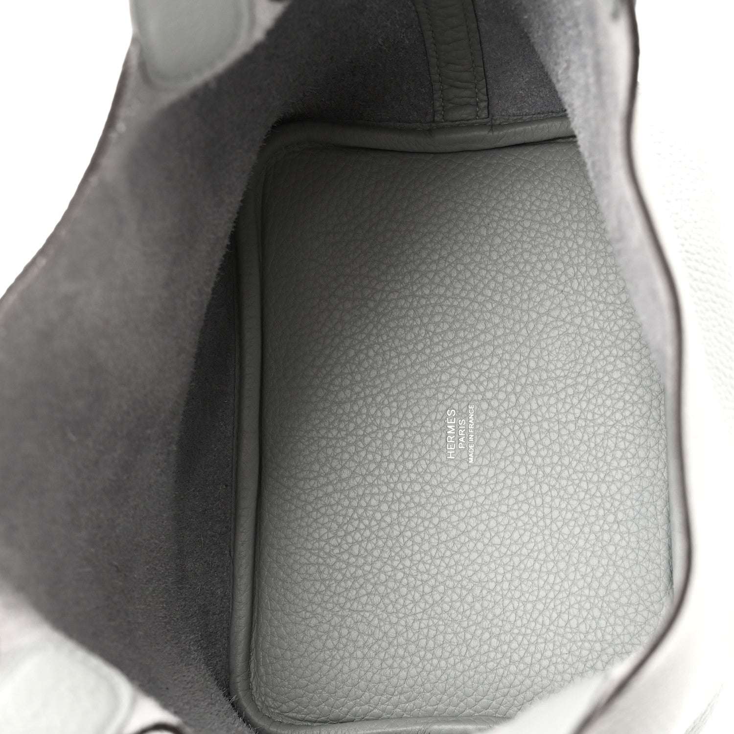 Interior view of light blue pebbled leather bucket bag with structured lining