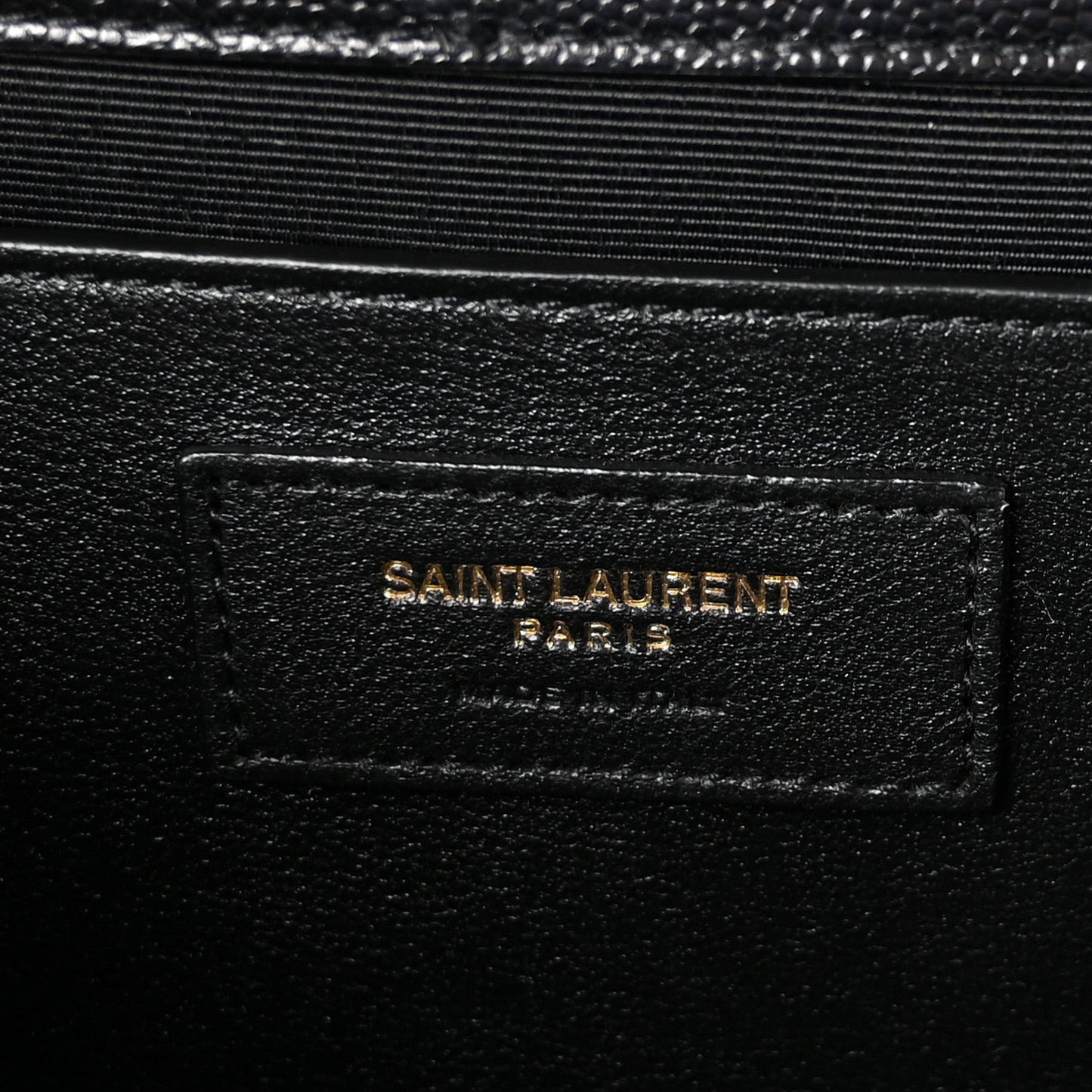 Black leather label patch reading “SAINT LAURENT PARIS” on satchel lining