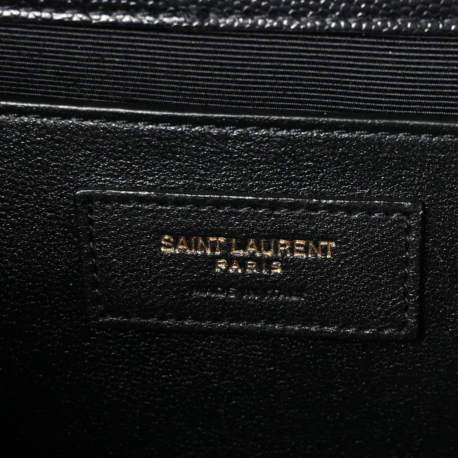 Black leather label patch reading “SAINT LAURENT PARIS” on satchel lining