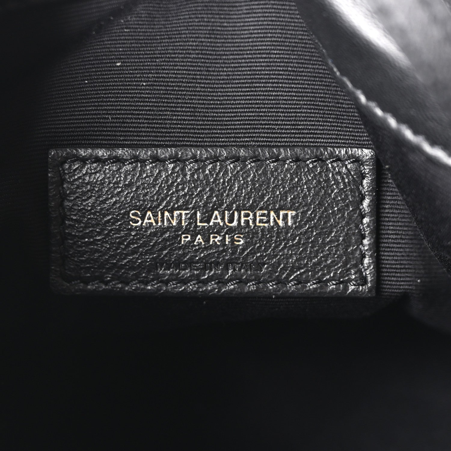 Black fabric lining label reading SAINT LAURENT PARIS